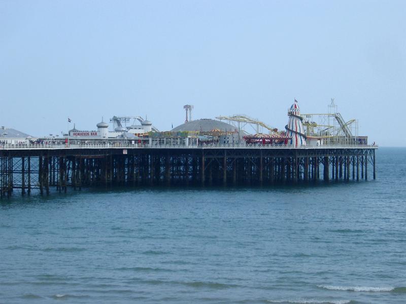View across the water of the Brighton Pier with its historical buildings now housing an amusement park and popular tourist attraction