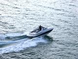 Aerial View of Man Travelling in a Small Speed Boat at Brighton Sea, England.