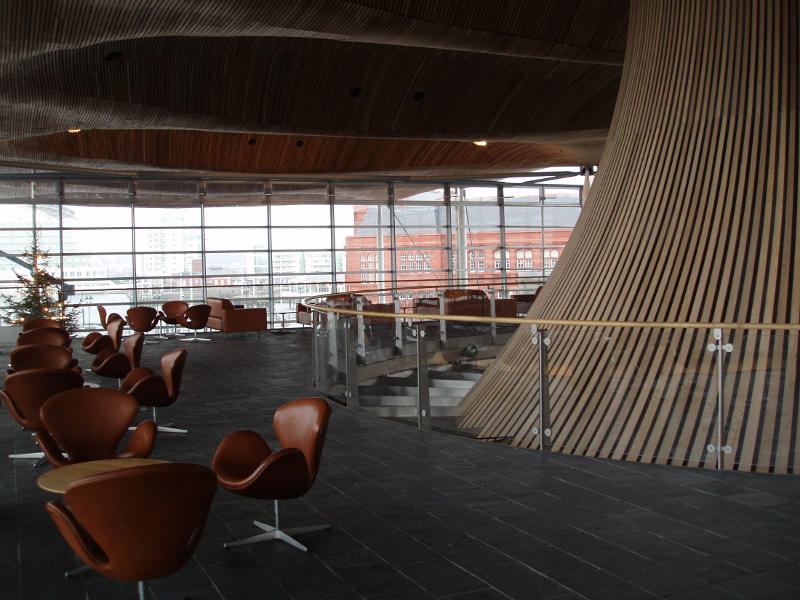Interior view of seating and tables in the Senedd, or national Assembley Building in Cardiff, Wales