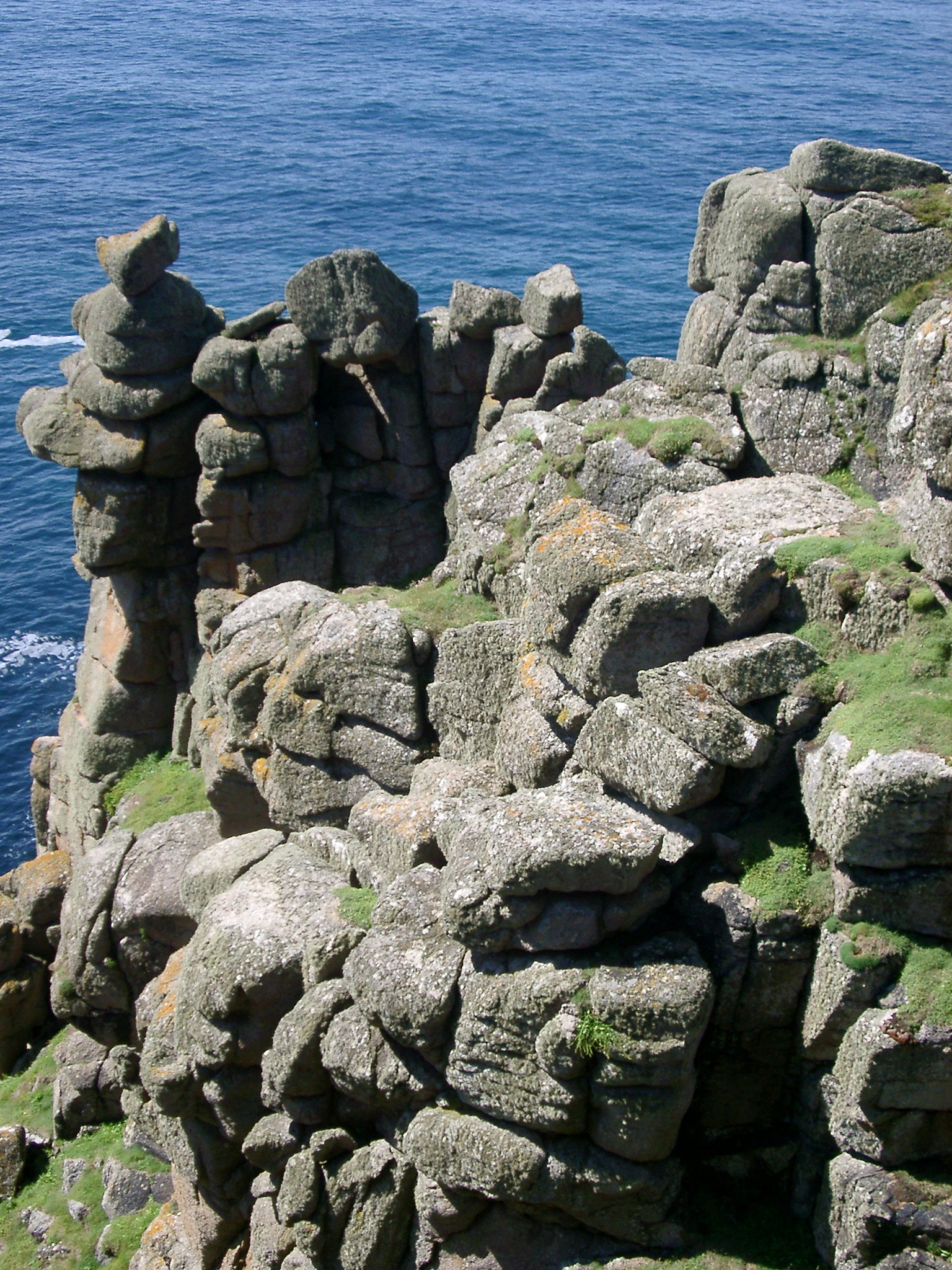 an image of erroded rock formations weathered by countless storms over the headland and lands end, cornwall
