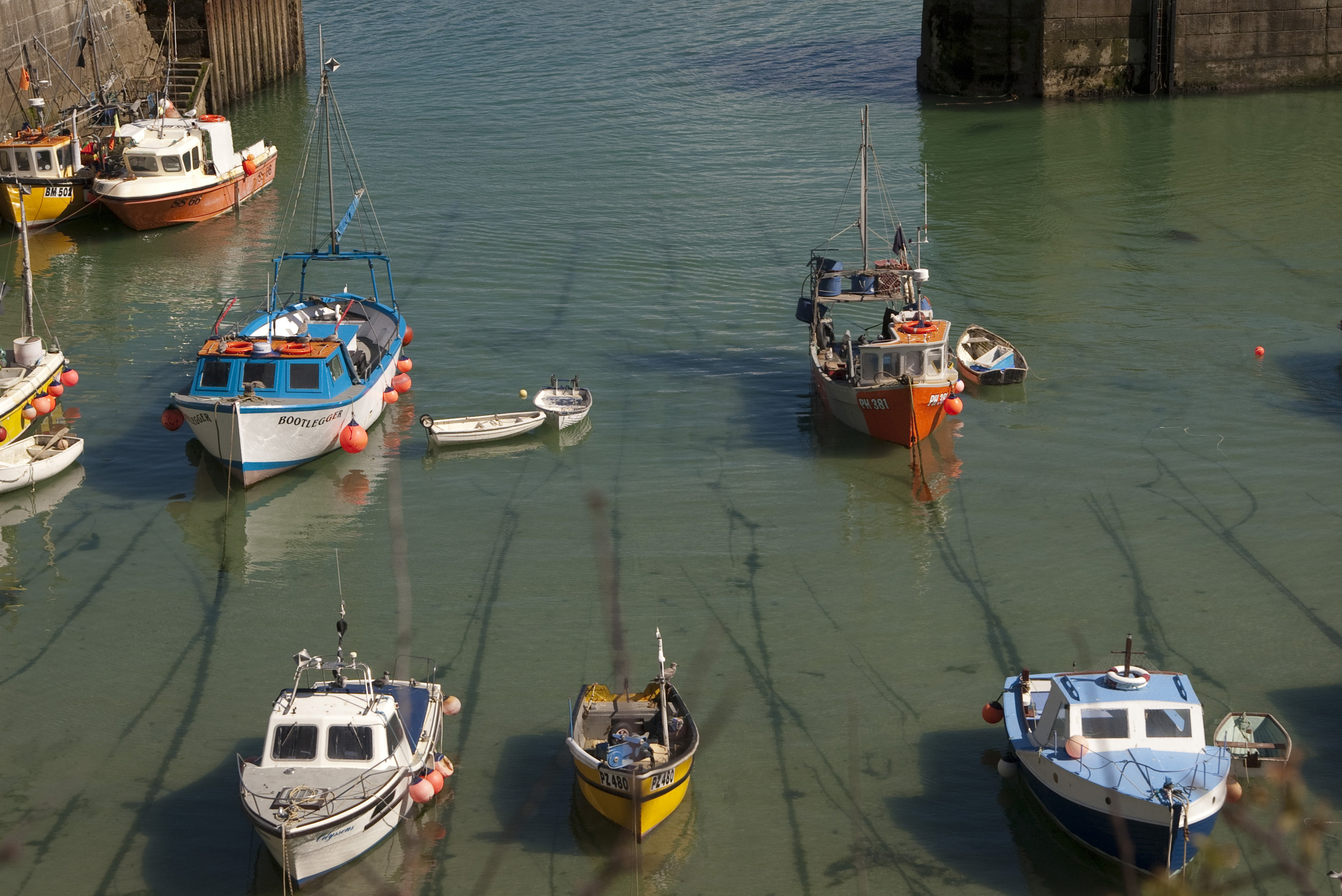 an image of small fishing boats in the harbour at newquay