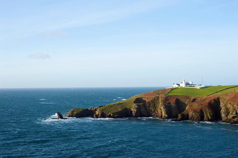 Lighthouse guides shipping around the rocks on england most southerly point