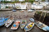 boats at low tide in polperro harbour