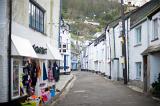 narrow street of white painted rustic built houses in polperro an unspoilt cornish fishing village