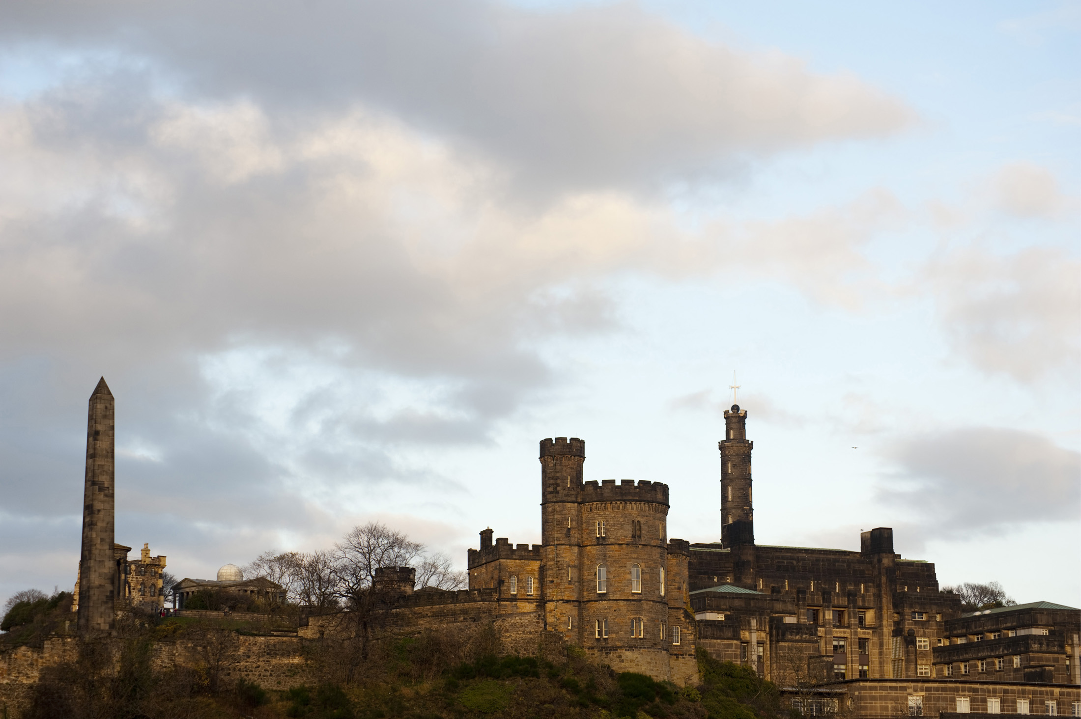 an image of Landmarks overlooking edinburgh on carlton hill, hamiltons obelisk, nelson monument and the governors house