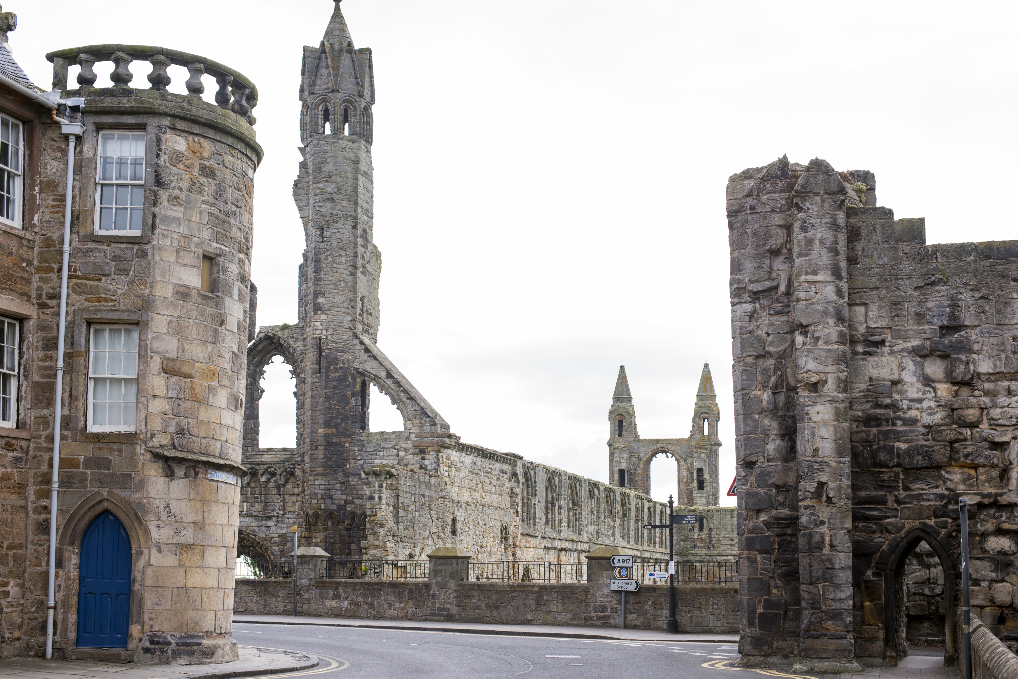 an image of Graceful spires and ruins of St Andrews Cathedral from the street with the rondel building in the foreground, the historic Scottish town of St Andrews