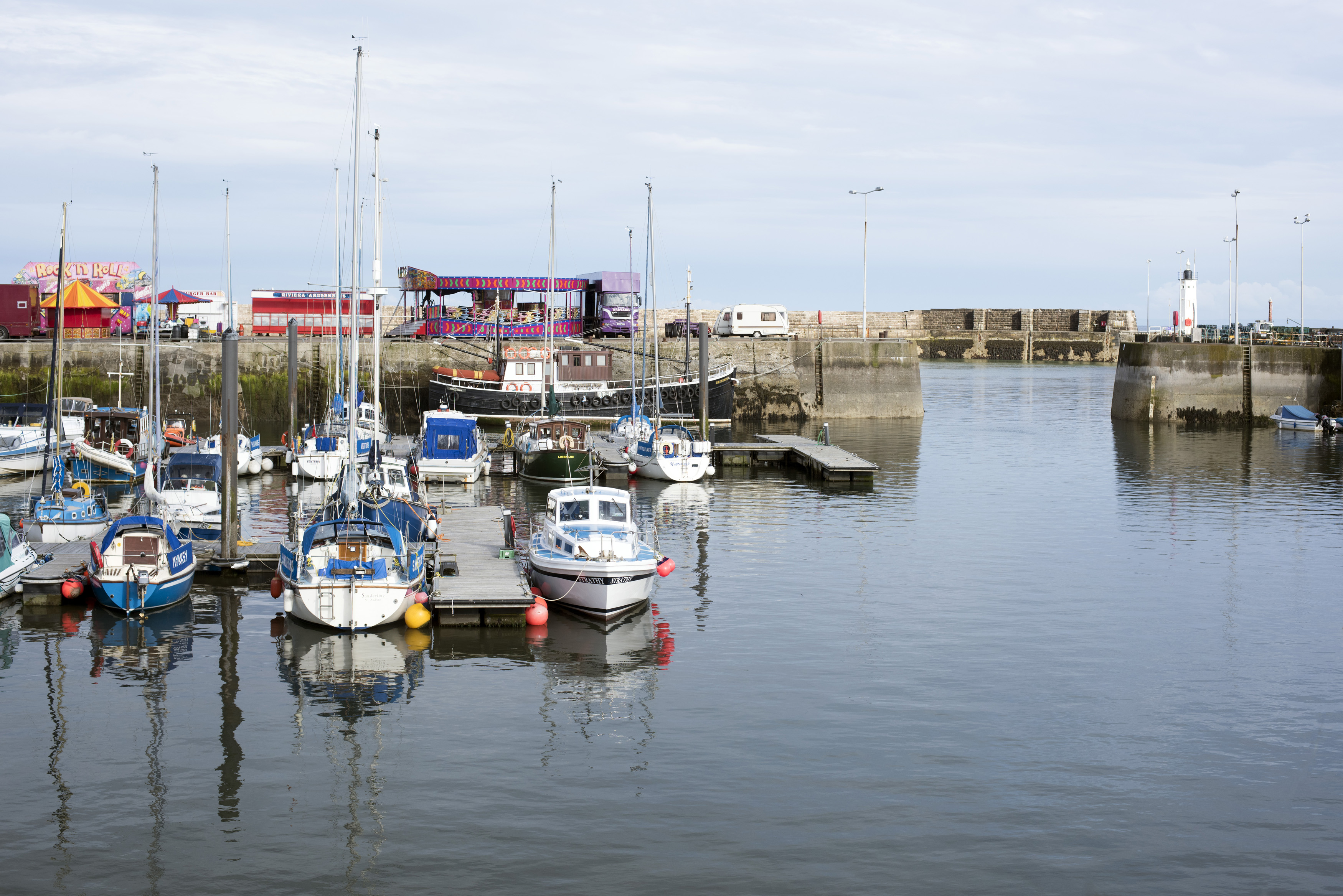 an image of Motorboats and sailboats moored in the sheltered water in Anstruther harbour, Fife coast, Scotland