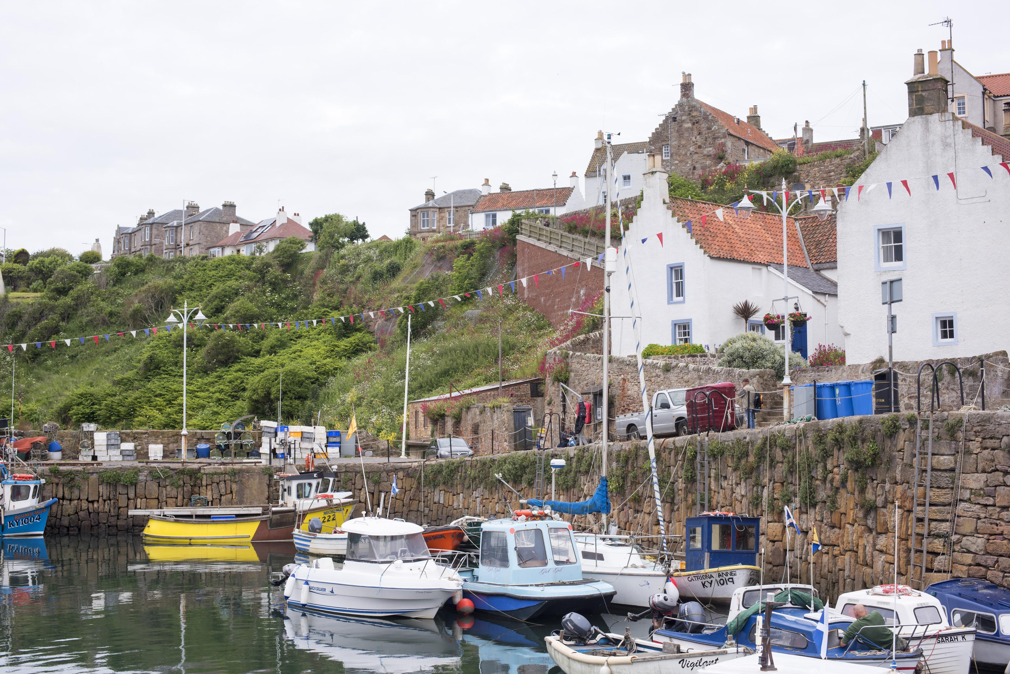 an image of Waterfront view of small fishing boats moored at Crail, Scotland, a picturesque fishing village on the Fife coast