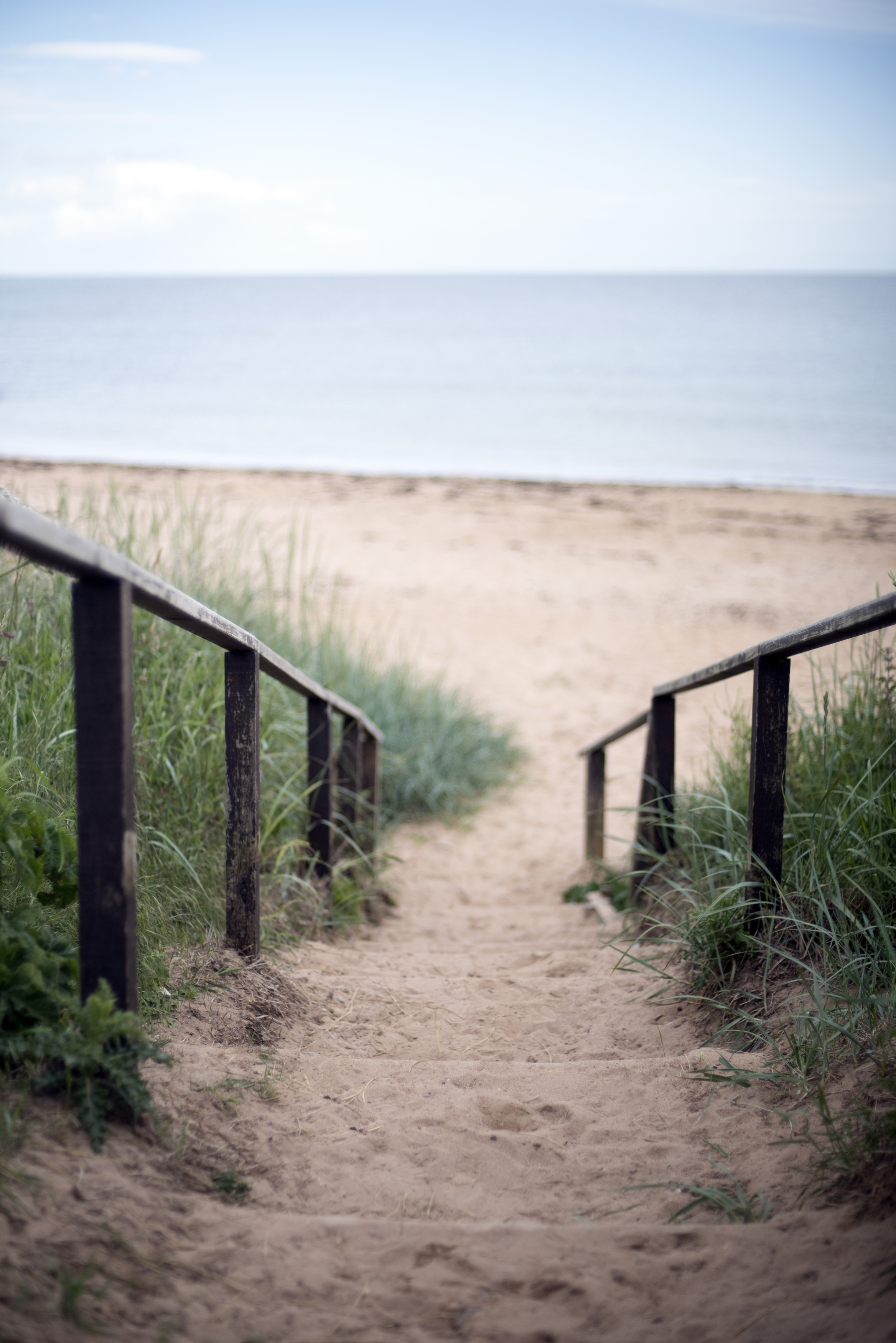 an image of Steps leading down to a sandy beach on the Fife coast of Scotland in a receding view