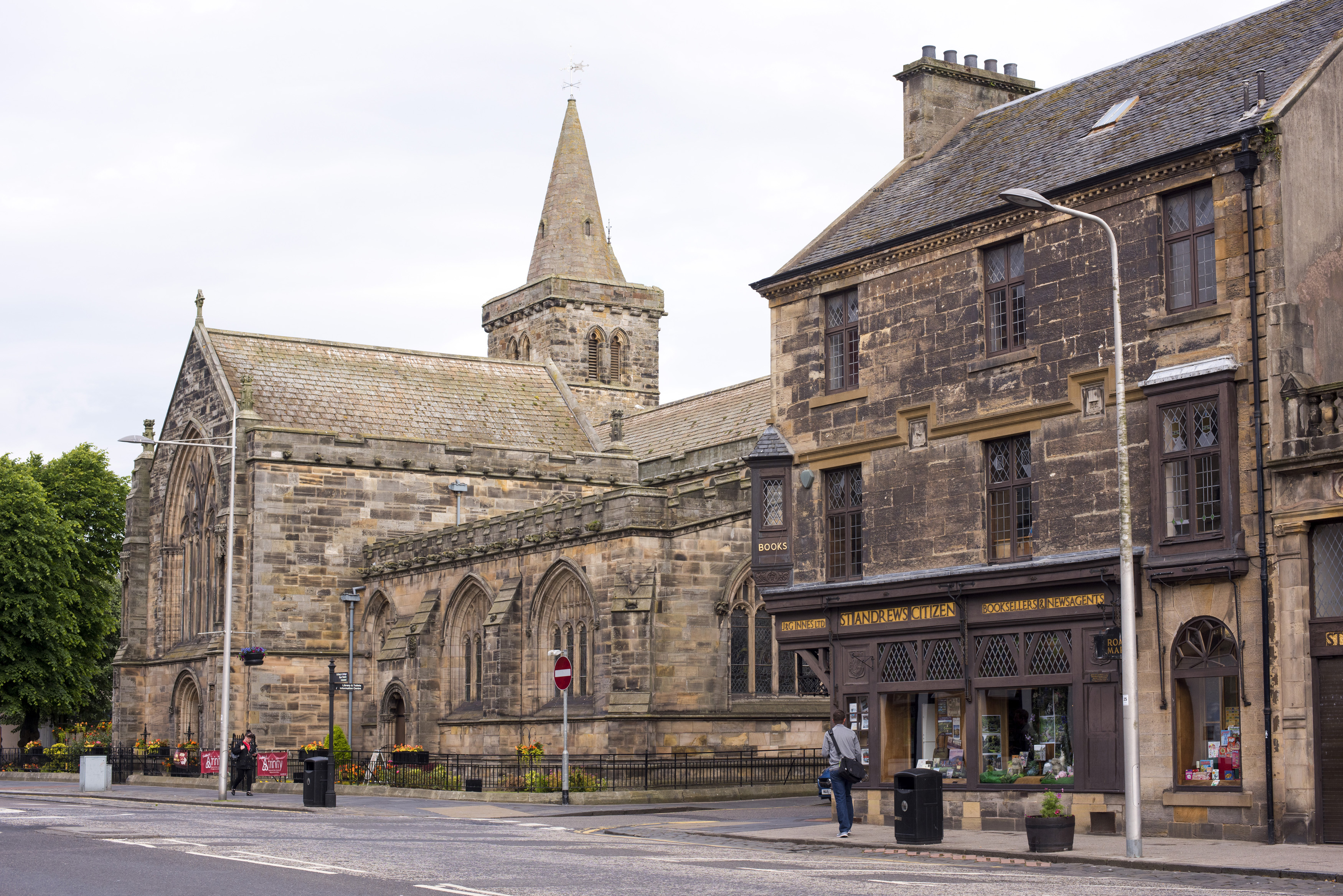 an image of Holy Trinity church sits on an empty street across another stone building