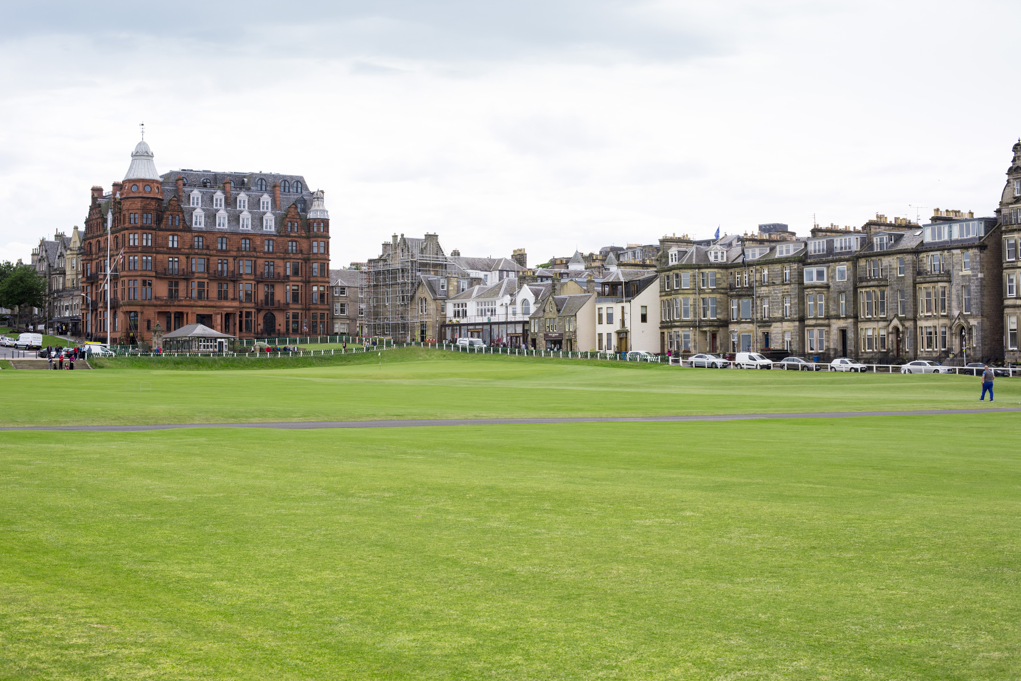 an image of View across the golf course of St Andrews, Scotland with its historic architecture and rows of town houses in a travel and sport concept