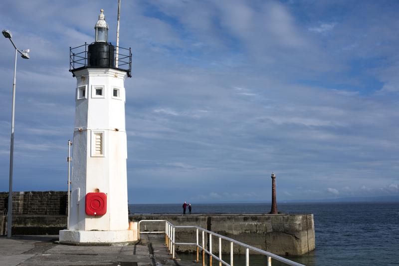 Picturesque white lighthouse, Anstruther, Scotland on the seawall at the entrance to the harbour with copy space on a blue sky