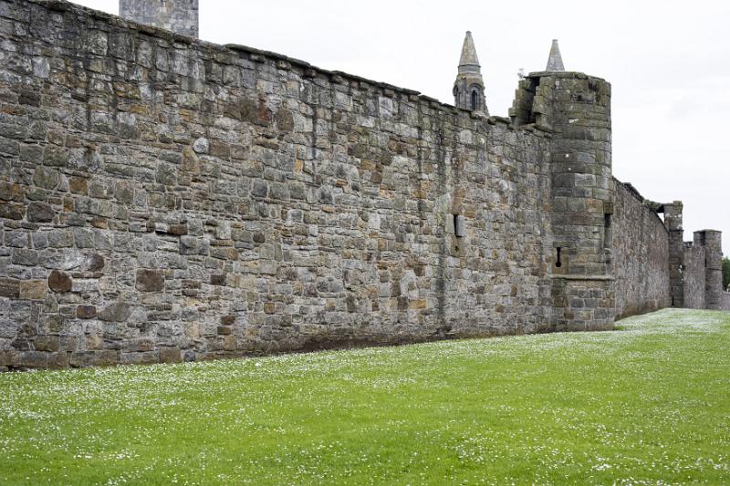 Ancient stone wall of the walled grounds of the St Andrews Cathedral ruins in the Scottish town of St Andrews in a receding perspective