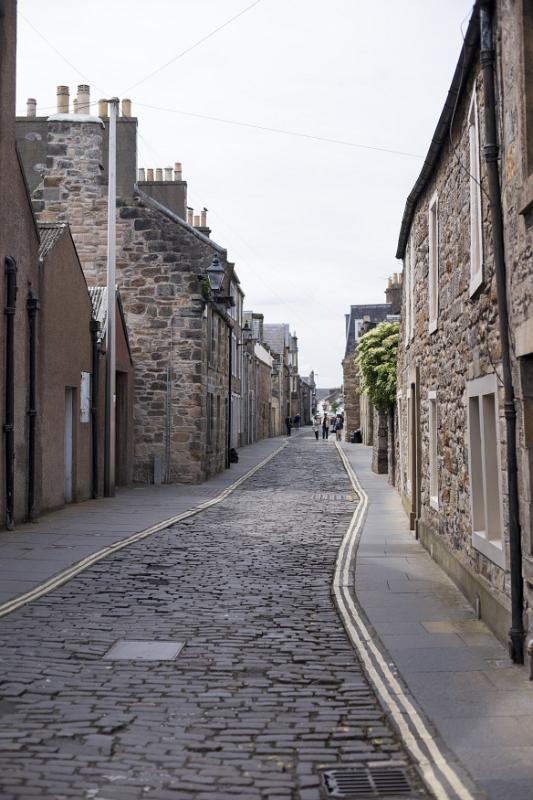 View down cobblestone street in the historic European town of Saint Andrews in Scotland