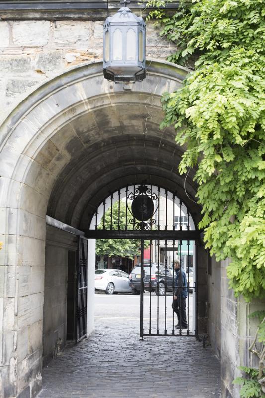Iron gate and stone archway at the historic European landmark University of Saint Andrews in Scotland