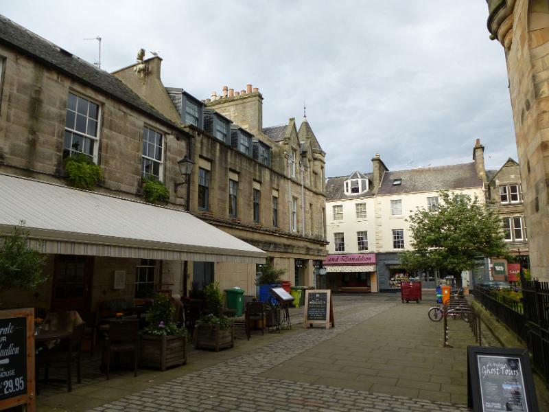 Open air restaurant on cobblestone street in quaint business area of Saint Andrews, Scotland