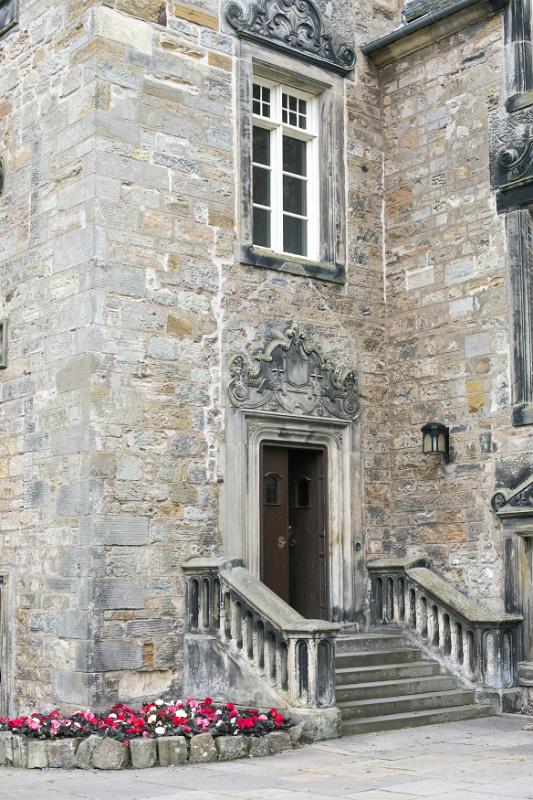 Stone stairway with little annual white, pink and red flowers at University of Saint Andrews in Scotland