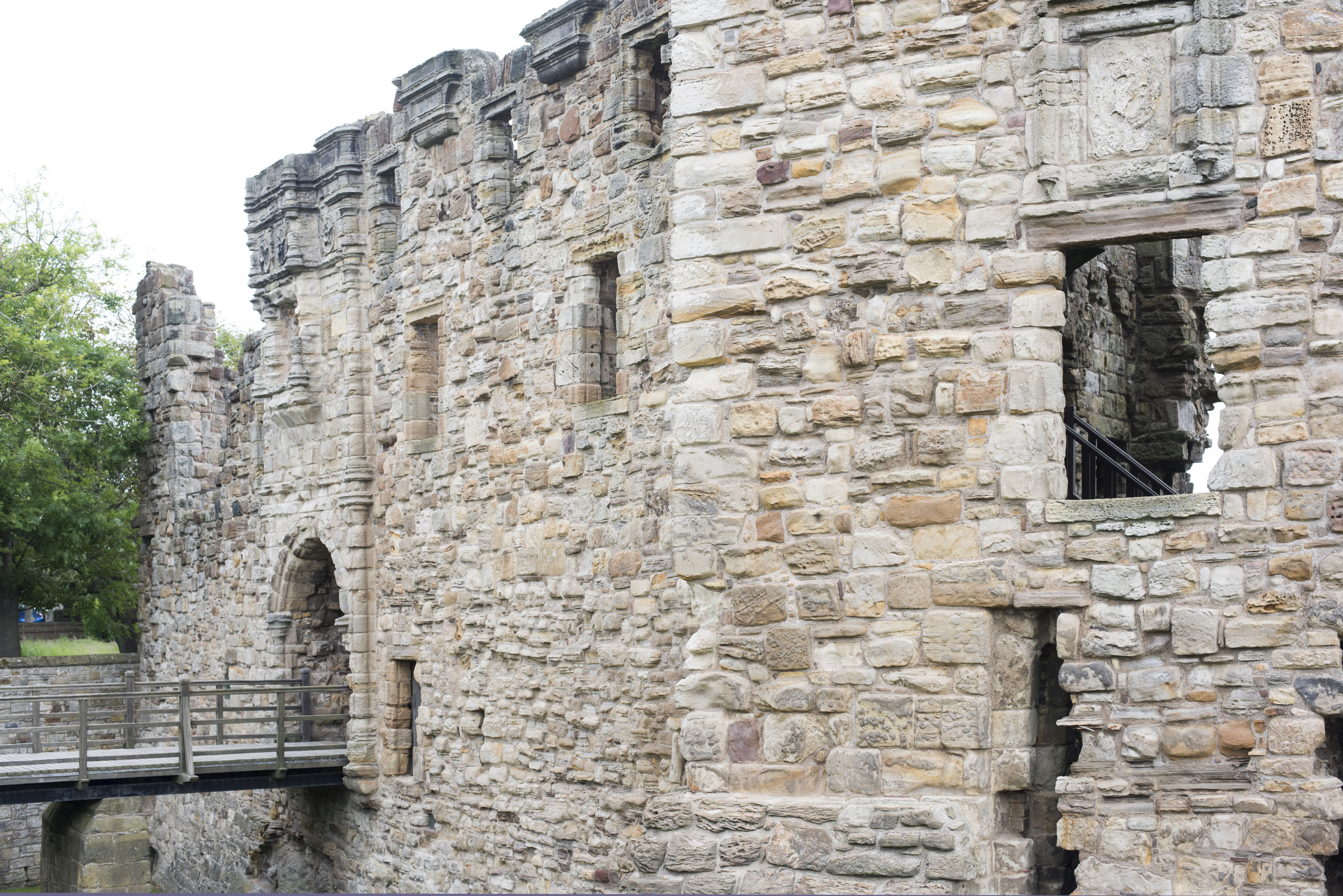 an image of Medieval stone walls and entrance of St Andrews Castle, Scotland situated on cliffs overlooking the ocean to the north of the town of St Andrews
