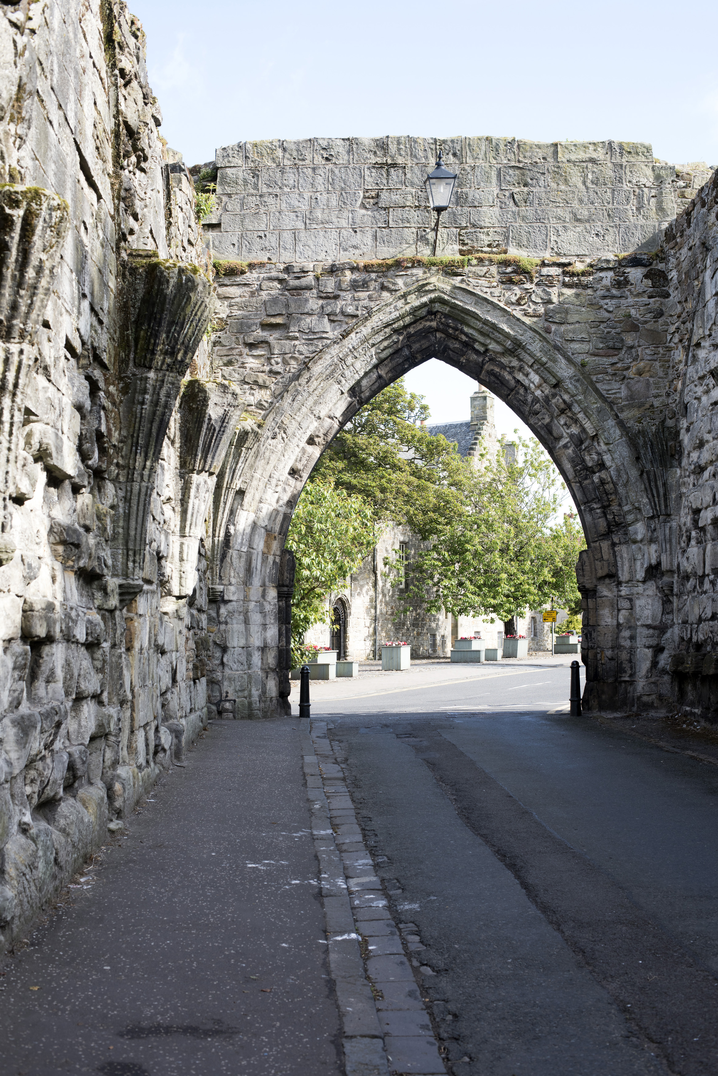 an image of Large equilateral type ancient archway in little street of historic Saint Andrews, Scotland