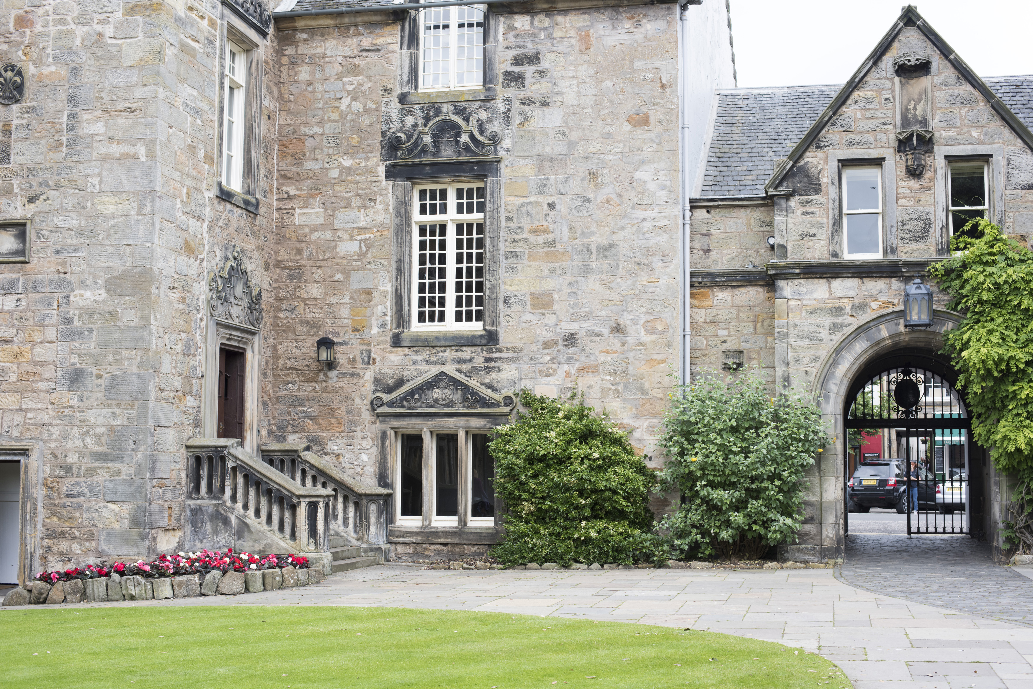 an image of Architecture of the University of St Andrews, Scotland, one of the most prestigious in the UK, with its old stone buildings and gated entrance