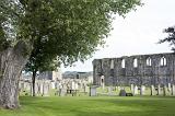 Gravestones and cemetery at St Andrews Cathedral, Scotland with the ruined walls of the historic building visible in the background