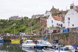 Waterfront view of small fishing boats moored at Crail, Scotland, a picturesque fishing village on the Fife coast