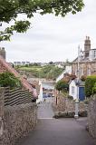 Down street view of old historic buildings and well manicured hedges of Crail in Scotland