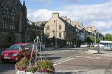 Scenic view of lovely Scottish village main street with a red car in foreground