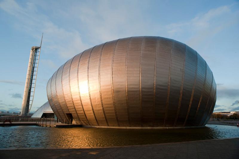 Modern curved external facade of the Glasgow IMAX cinema with its huge 3d screen alongside the Glasgow Tower on the River Clyde