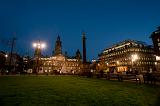 George Square in Glasgow at night with lights illuminating the historical buildings of the Glasgow City Council