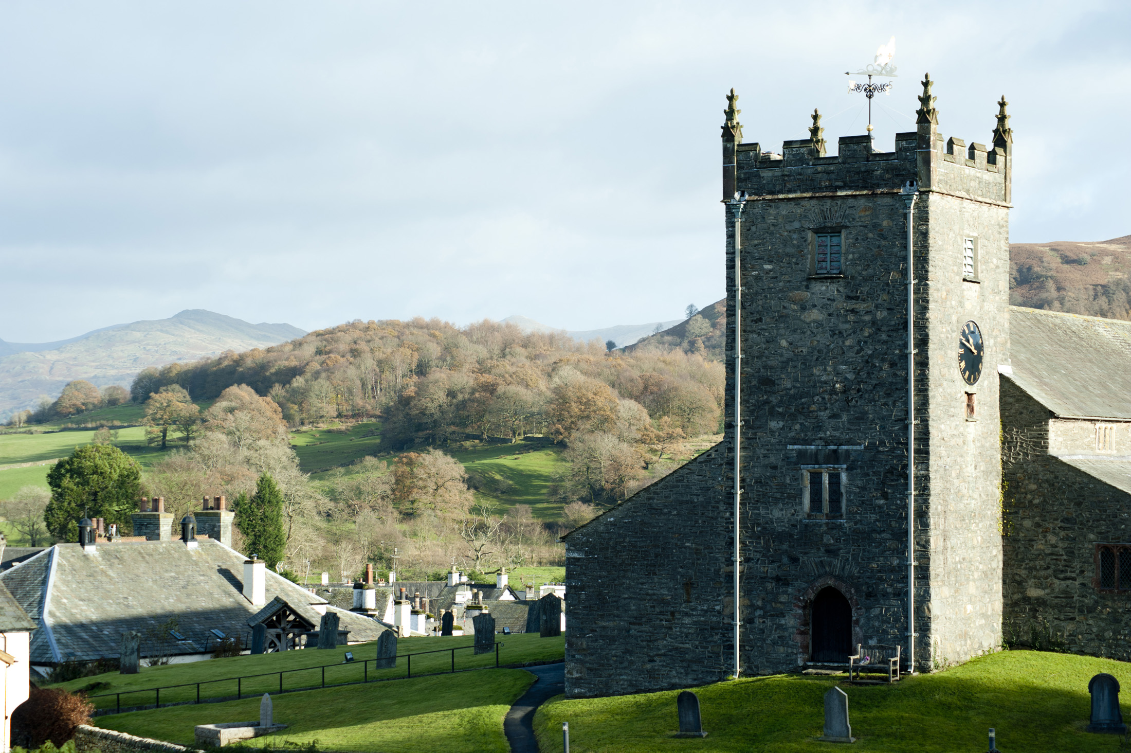an image of A view of the hawkshead church on a hill overlooking the village and beautiful surrounds