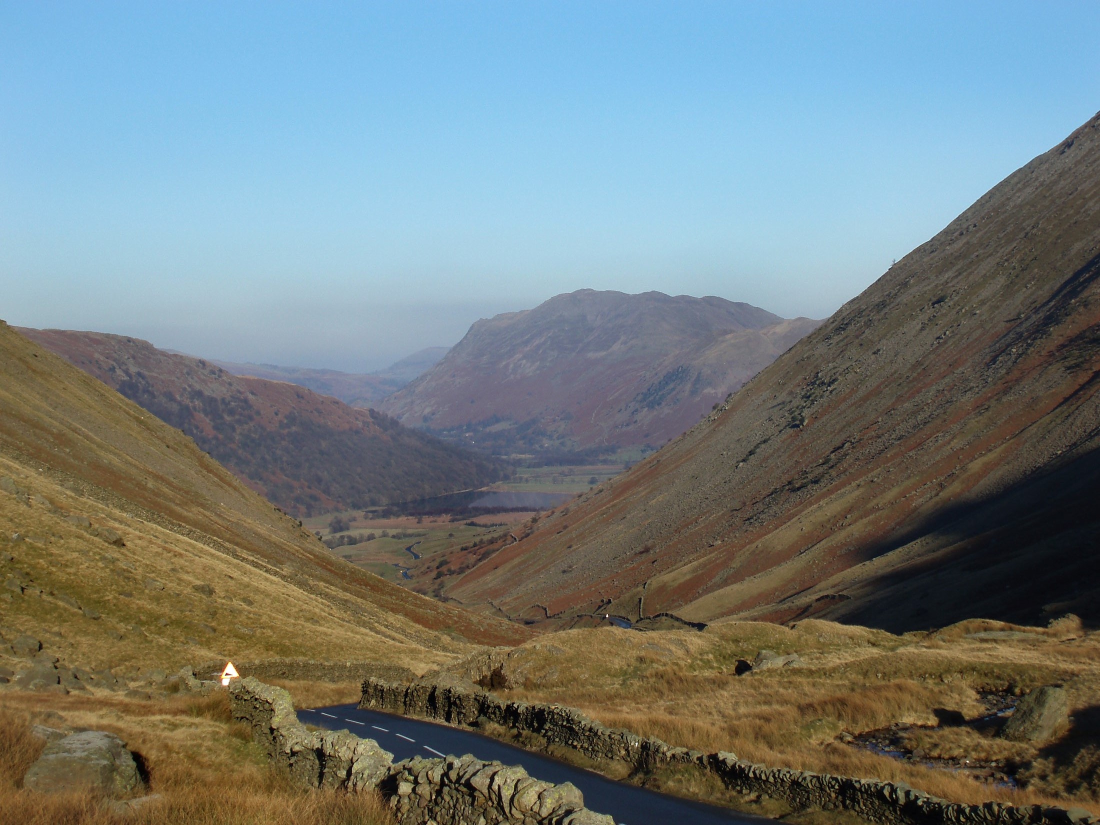 an image of kirkstone pass road down towards ullswater, cumbria