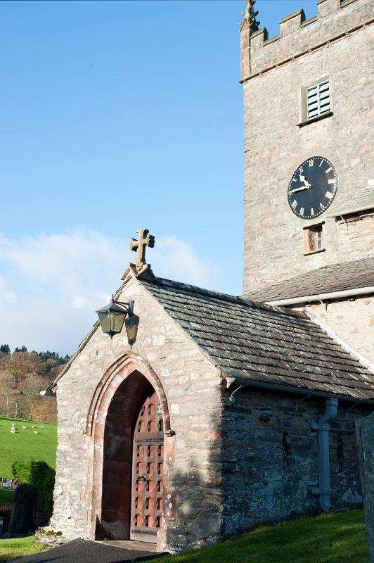 Entrance to St Michael and All Angels stone church in the quaint village of Hawkshead in the Lake District in Cumbria, England