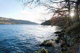 sun glinting over the surface of coniston water in the english lake district