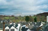 View over the rooftops of the quaint village of Hawkshead in the English Lake District with its picturesque whitewashed cottages to the countryside beyond