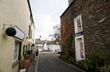 Narrow street in Hawkshead village, Cumbria lined with historical stone cottages typical of the architecture of the English Lake District
