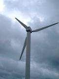 a wind turbine against a stormy sky over a cumbiran fell