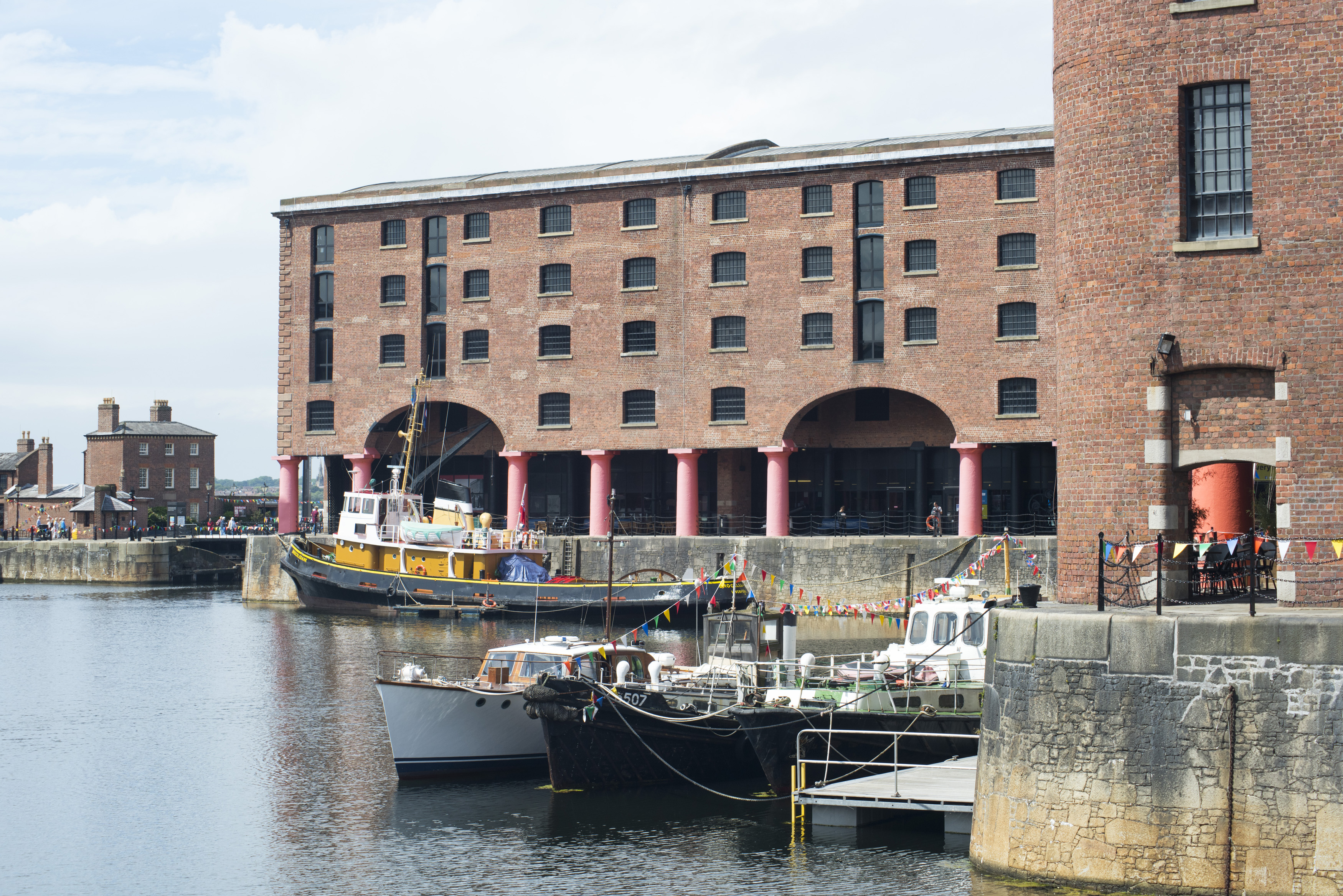 an image of Various small boots moored on floating docks in the waterfront at Liverpool Albert during daytime