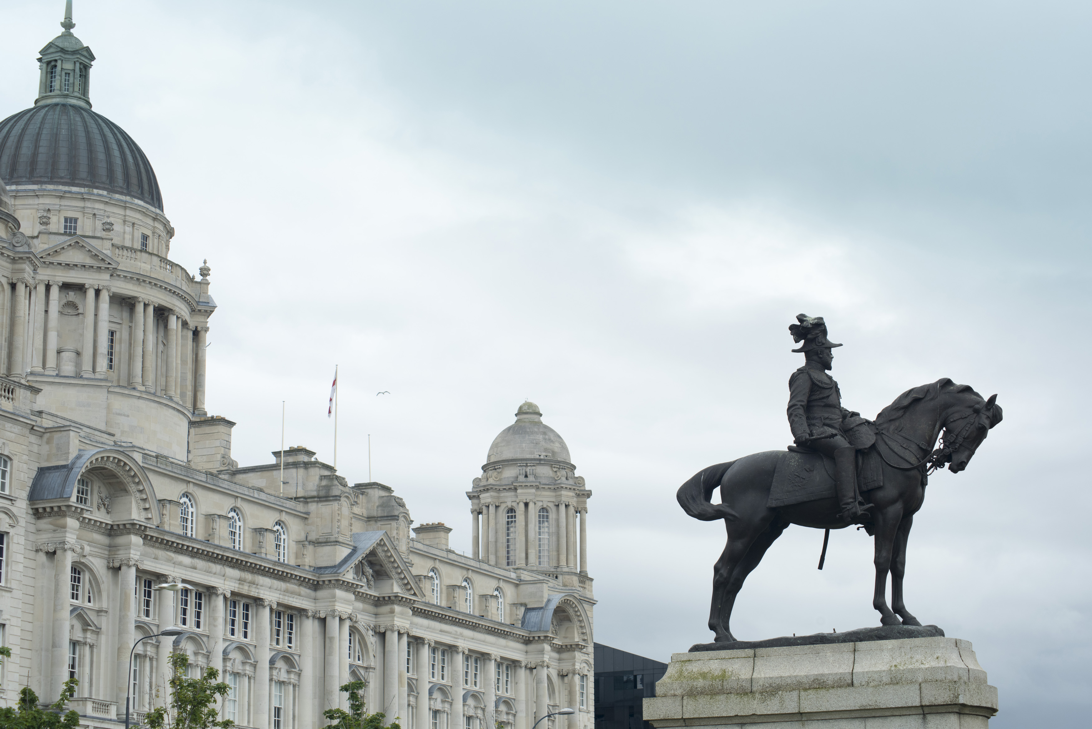 an image of Statue of Edward VII on horse under overcast gray sky in Liverpool, United Kingdom. Includes copy space.