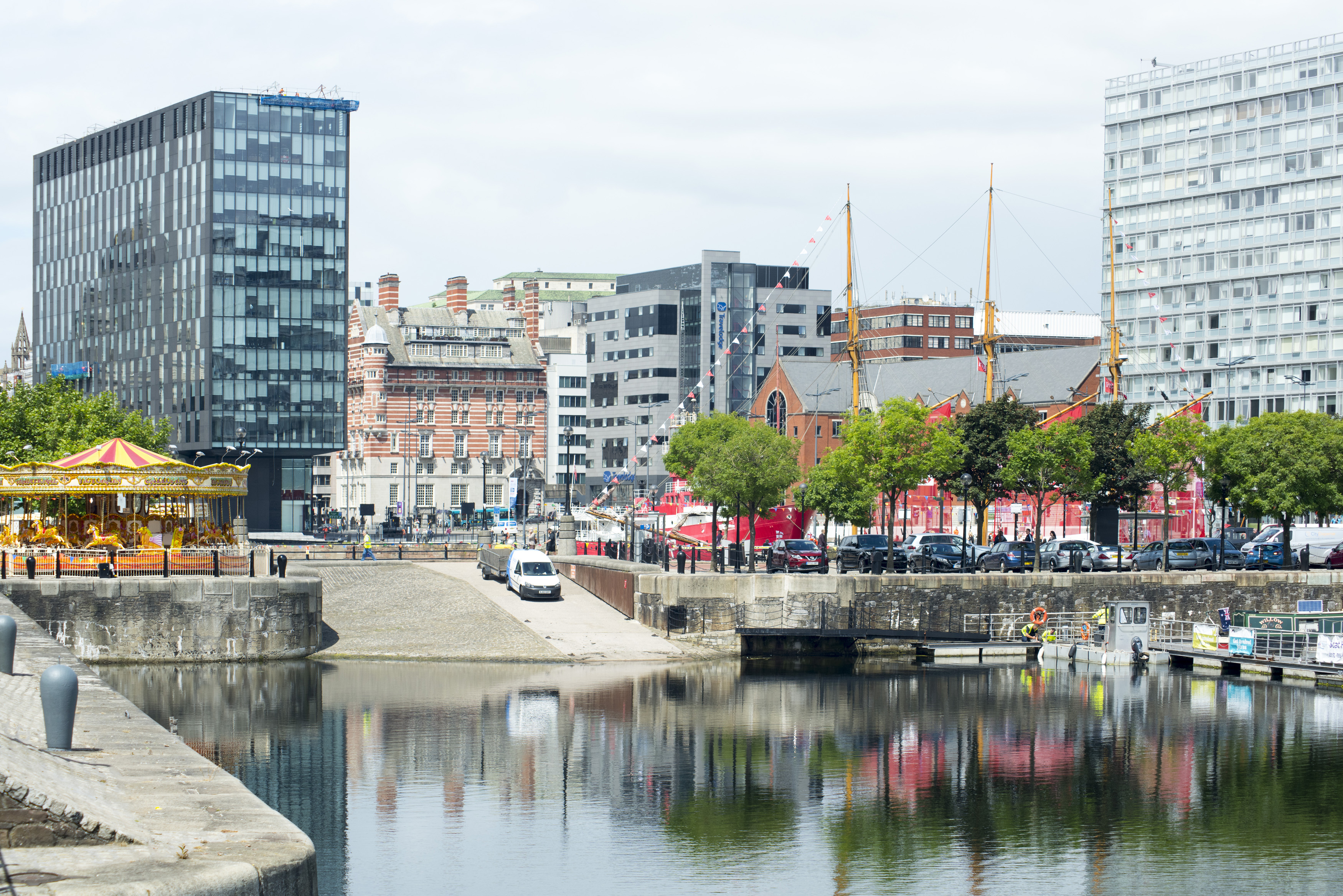 an image of View of merri-go-round and dock on waterfront at Liverpool in the United Kingdom