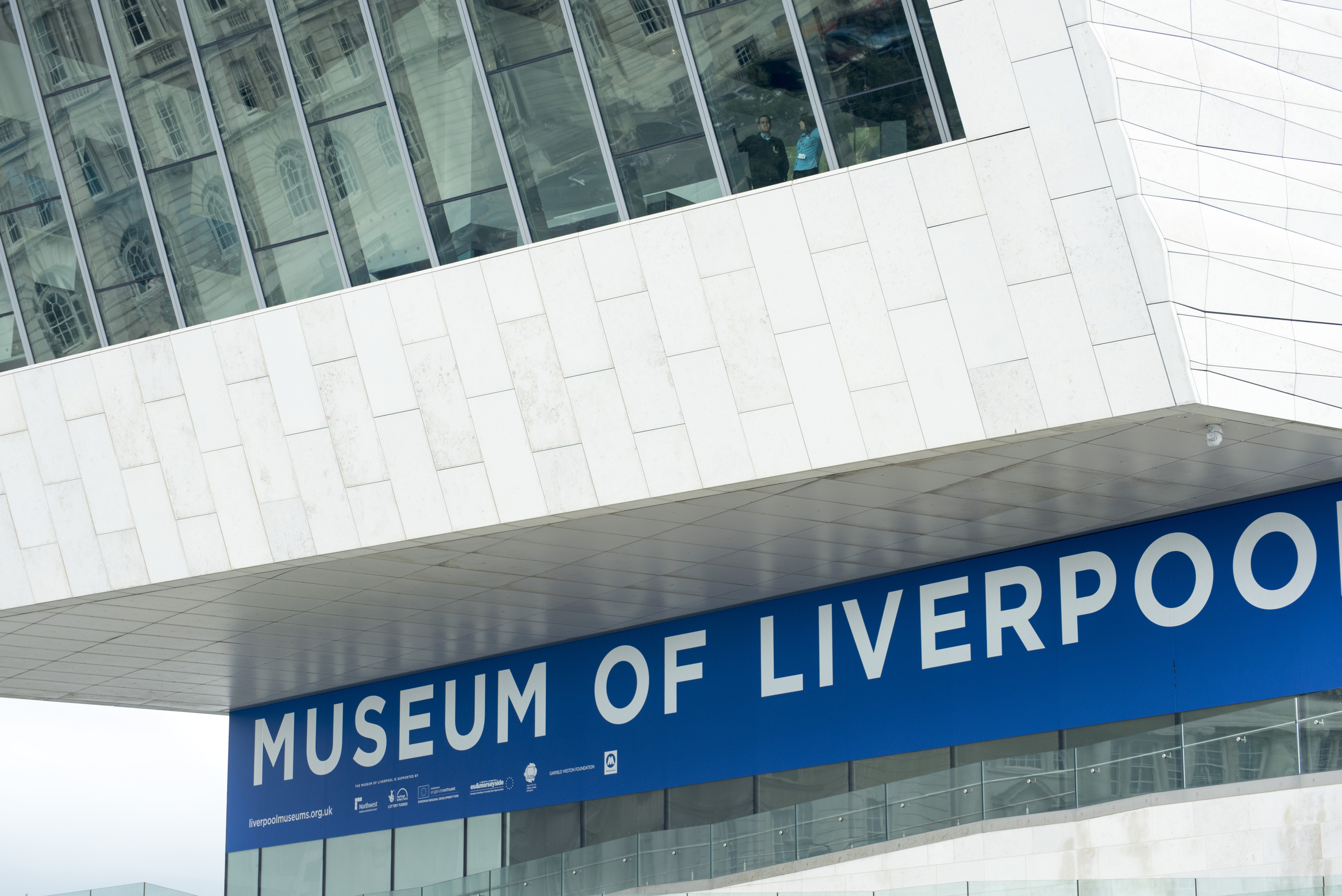 an image of Large overlook with tall glass windows above sign for the Museum of Liverpool in the United Kingdom