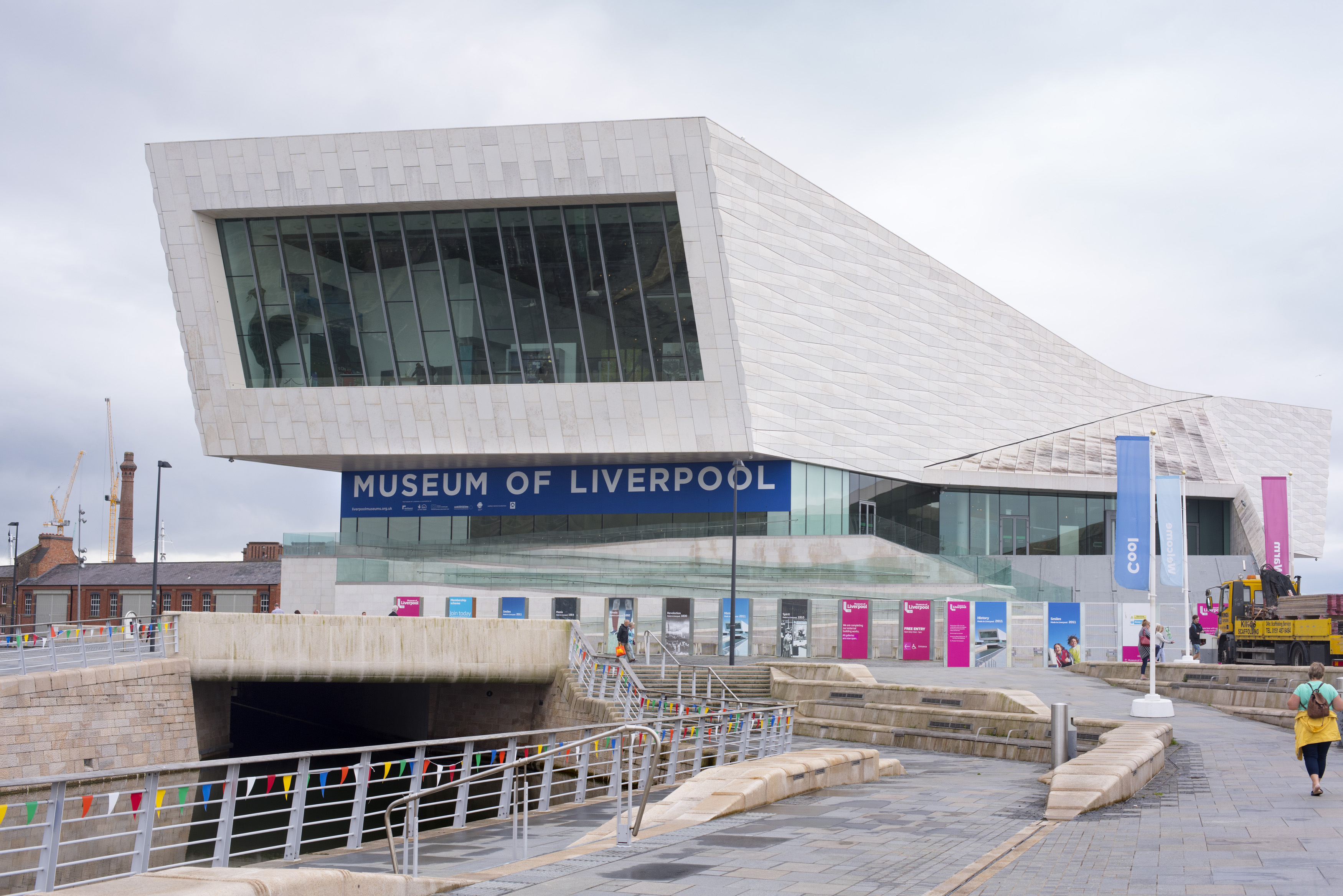 an image of Person walking up road near front section of the Museum of Liverpool in the United Kingdom