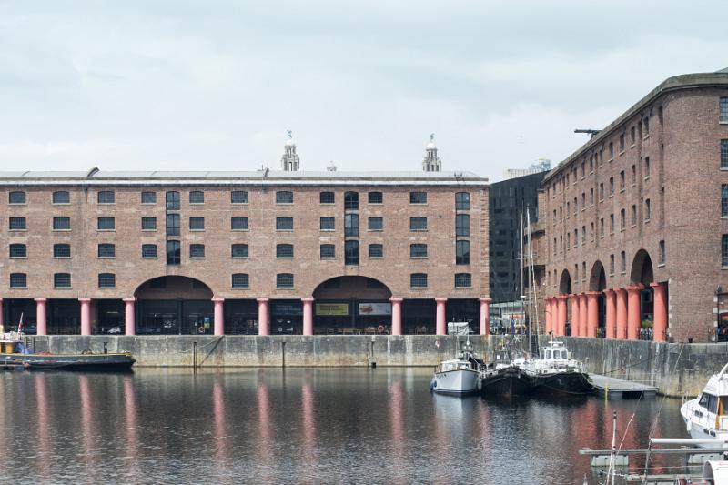 Various small boats docked at the famous tourist landmark destination of Liverpool Albert in the United Kingdom
