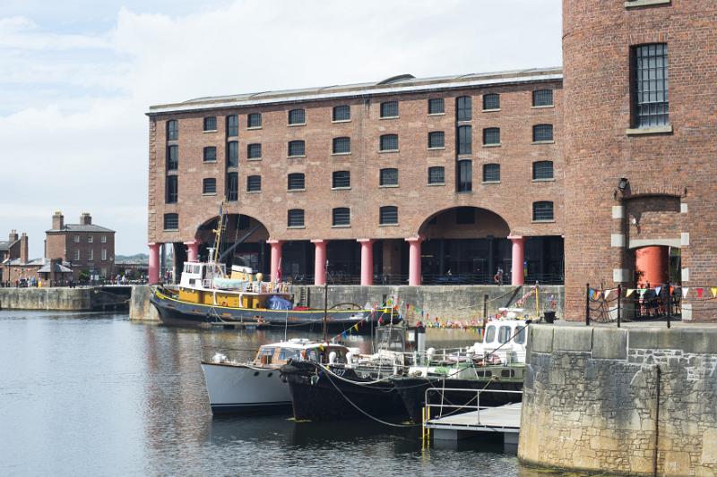 Various small boots moored on floating docks in the waterfront at Liverpool Albert during daytime