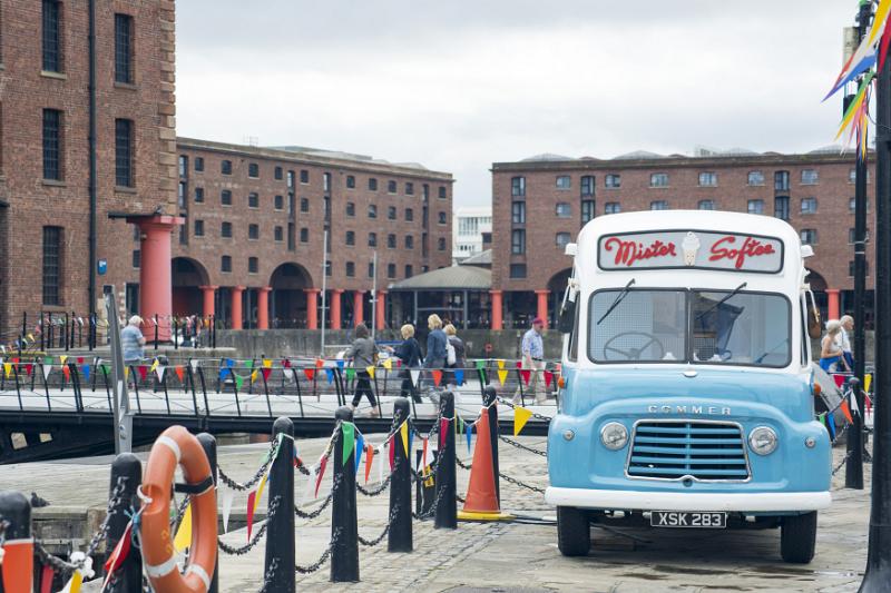 Old traditional ice cream van, Liverpool, England parked at the waterfront with people walking in the background