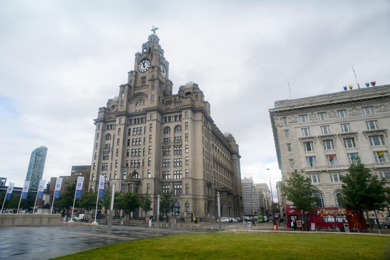 Low angle view of Liver Building in Liverpool under cloudy skies with slight rainfall
