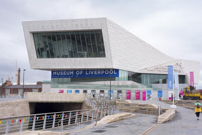 Person walking up road near front section of the Museum of Liverpool in the United Kingdom