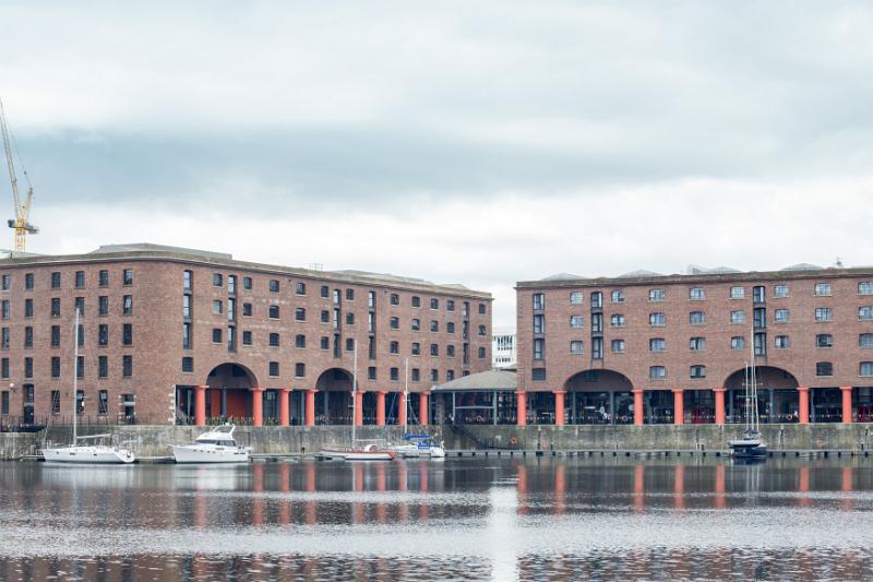 View from across the water of historic Liverpool Albert Dock with docked boats