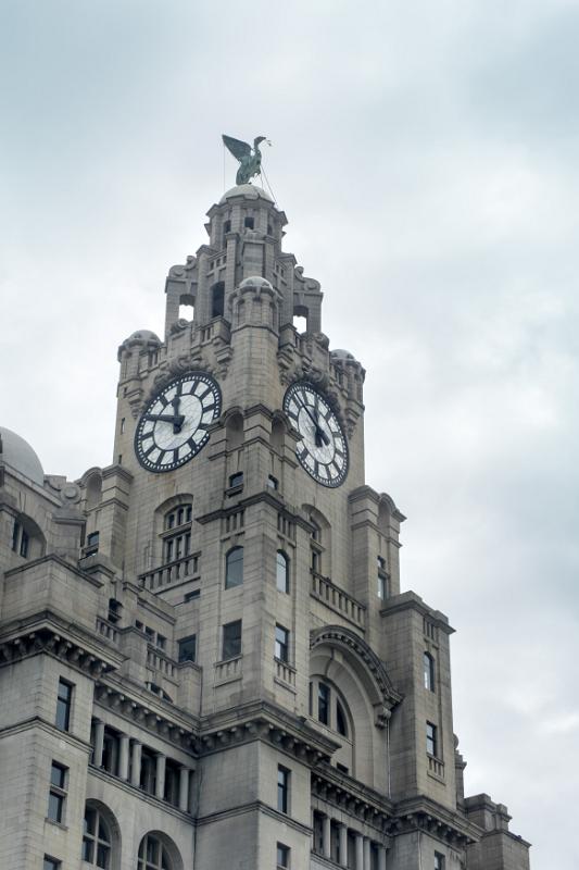 Low angle view of the Liver Building under cloudy sky in Liverpool, United Kingdom