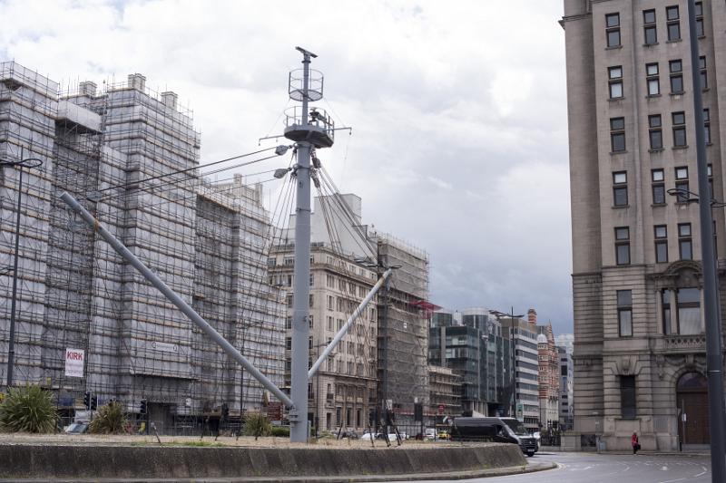 Large ship mast structure surrounded by buildings in Liverpool, United Kingdom